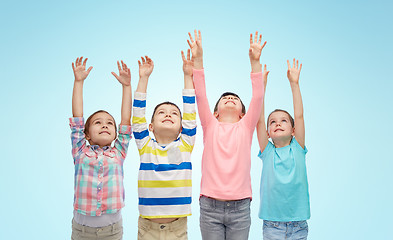 Image showing happy children celebrating victory over blue