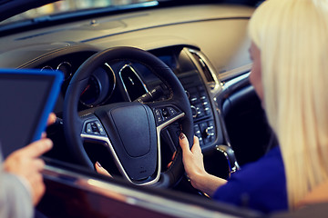 Image showing woman and car dealer with tablet pc in auto salon