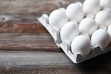 Image showing White chicken eggs on old wooden table