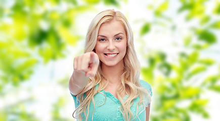 Image showing happy young woman pointing finger to you