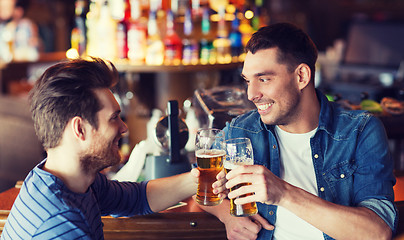 Image showing happy male friends drinking beer at bar or pub