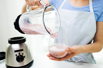Image showing close up of woman with blender and shake at home