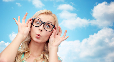 Image showing happy young woman in glasses making fish face