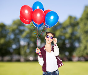 Image showing happy teenage girl with helium balloons