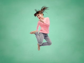 Image showing happy little girl jumping in air over school board