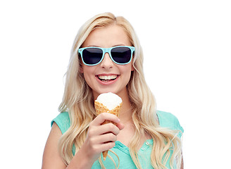 Image showing happy young woman in sunglasses eating ice cream