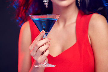 Image showing close up of woman with cocktail at nightclub