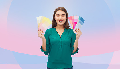 Image showing smiling young woman with color swatches