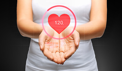 Image showing close up of womans hands showing heart beat icon