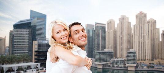 Image showing happy couple having fun over dubai city background