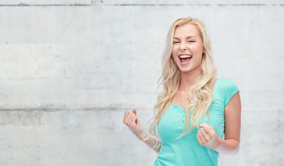 Image showing happy young woman or teen girl celebrating victory