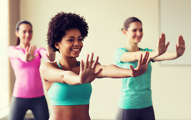 Image showing group of smiling people dancing in gym or studio