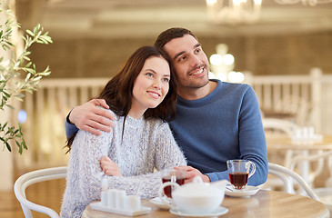 Image showing happy couple drinking tea at restaurant