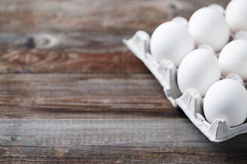 Image showing White chicken eggs on old wooden table