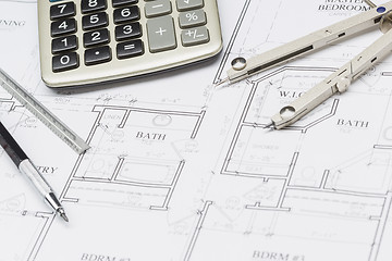 Image showing Pencil, Ruler, Compass and Calculator Resting on House Plans