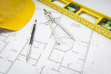 Image showing Hard Hat, Pencil, Level and Compass Resting on House Plans