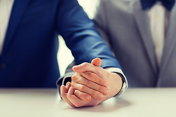 Image showing close up of happy male gay couple holding hands