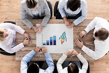 Image showing close up of business team sitting at table