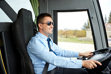 Image showing happy driver driving intercity bus