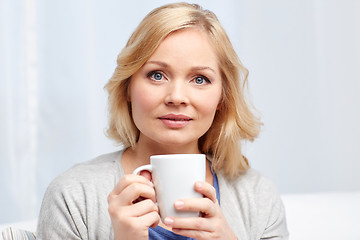 Image showing woman with cup of tea or coffee at home