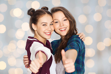 Image showing happy smiling teenage girls showing thumbs up