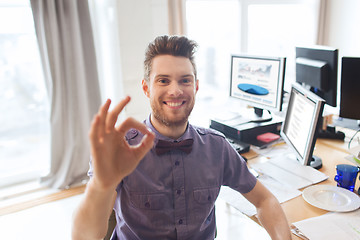 Image showing happy creative male office worker showing ok sign