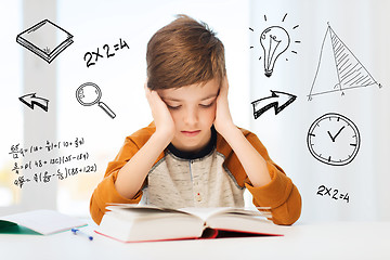 Image showing student boy reading book or textbook at home