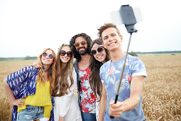 Image showing hippie friends with smartphone on selfie stick