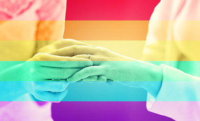 Image showing close up of lesbian couple hands with wedding ring