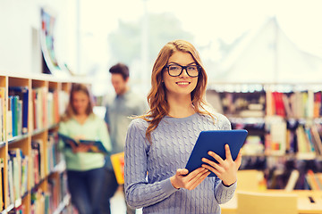 Image showing happy student girl with tablet pc in library