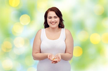 Image showing happy plus size woman in underwear with pills