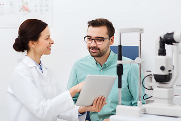 Image showing optician with tablet pc and patient at eye clinic