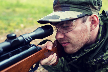 Image showing close up of soldier or hunter with gun in forest