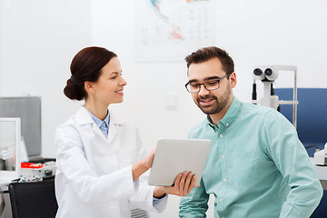 Image showing optician with tablet pc and patient at eye clinic