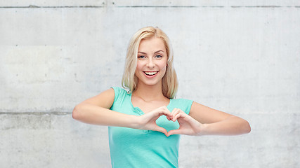 Image showing happy woman or teen girl showing heart shape sigh