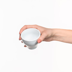 Image showing Woman hand with cup on white background