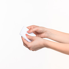 Image showing Female hand holding blank paper for records on white.