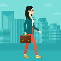 Image showing Business woman walking with briefcase. 