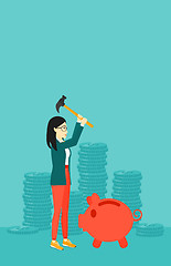 Image showing Woman breaking piggy bank.