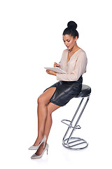 Image showing Business woman sitting on the chair and making notes