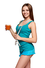 Image showing Happy teen girl holding a glass of carrot juice