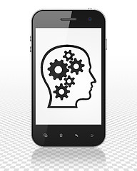 Image showing Business concept: Smartphone with Head With Gears on display