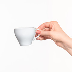 Image showing Woman hand with cup on white background