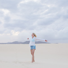 Image showing Carefree woman enjoying freedom on beach.