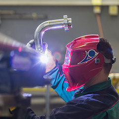 Image showing Industrial worker welding in metal factory.