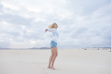 Image showing Carefree woman enjoying freedom on beach.