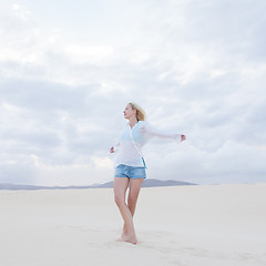 Image showing Carefree woman enjoying freedom on beach.