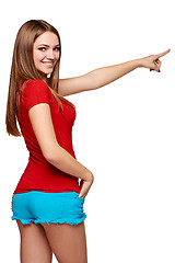 Image showing Back view of a young female pointing at copy space