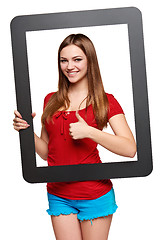 Image showing Female looking through the frame giving thumb up