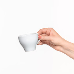 Image showing Woman hand with cup on white background